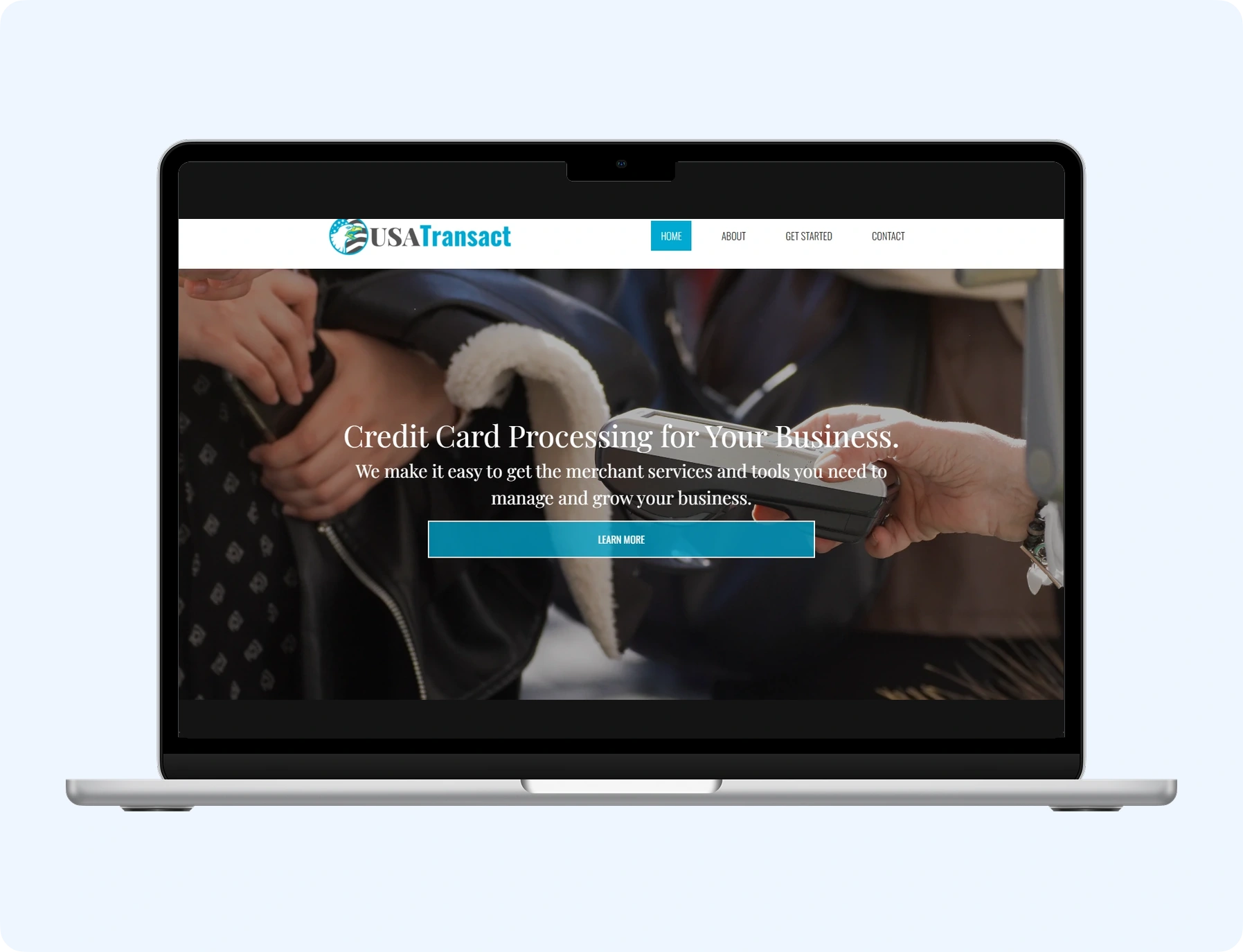 USA Transact merchant services homepage displayed in a MacBook mockup